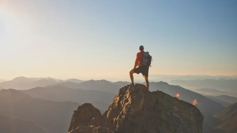 hiker on top of peak